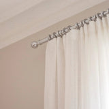 Metal curtain pole and rings in chrome