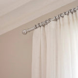 Metal curtain pole and rings in chrome